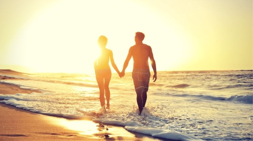 Couple walking on the beach walking