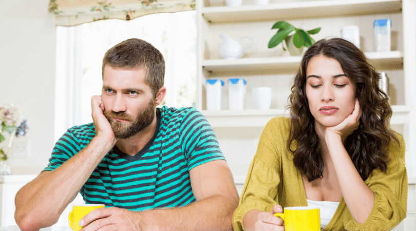 couple upset and not talking to each other at the table