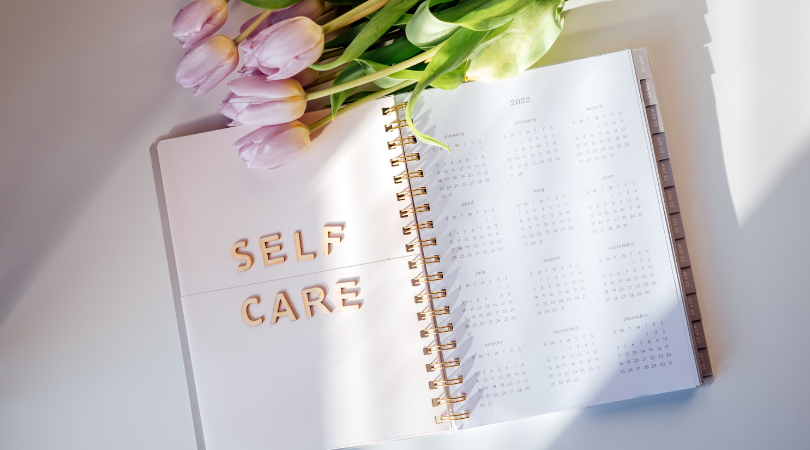open journal with the words "self care"