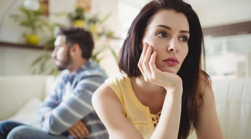 couple sitting away from each other upset