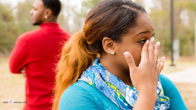 Woman crying with man with his back turned the other way