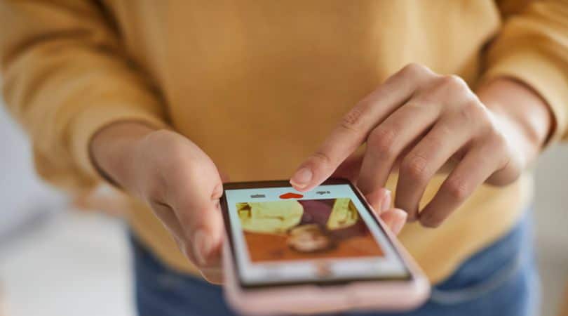 woman with smartphone clicking away at phone