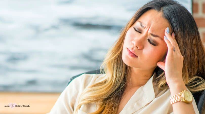 asian woman feeling stressed with her hand on her head