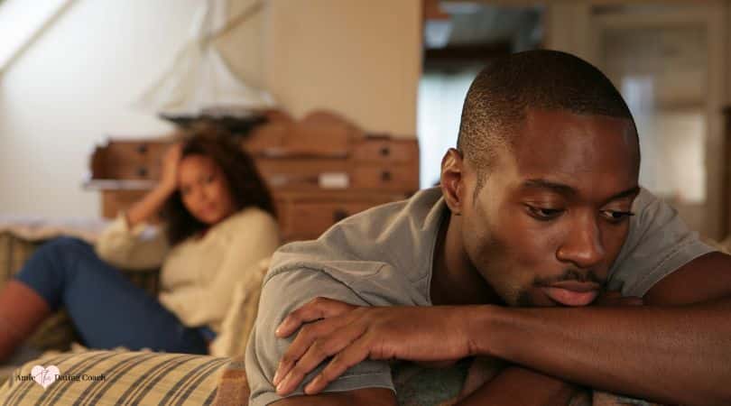 couple not talking to each other sitting apart on couch