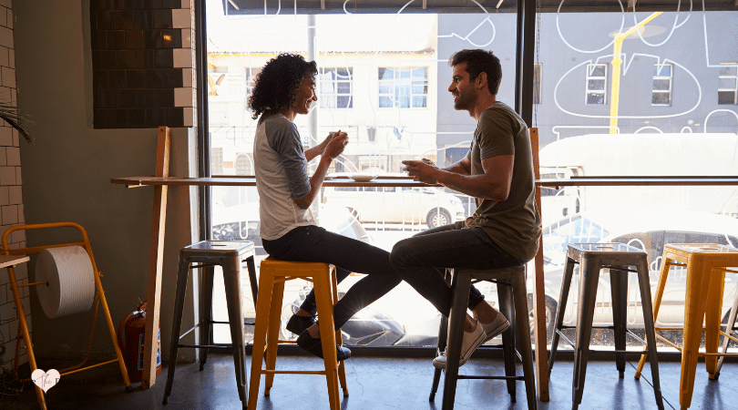 couple sitting at a coffee shop talking