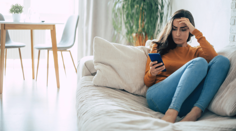 woman frustrated looking at phone