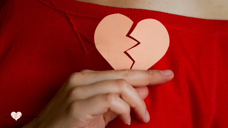 woman holding a paper broken heart