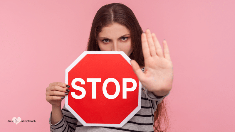 woman holding a stop sign and holding her hand as stop