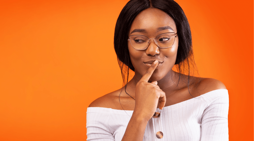 woman thinking about something with her hand over her mouth