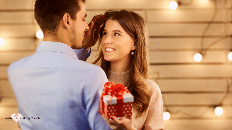couple holding each other with a gift
